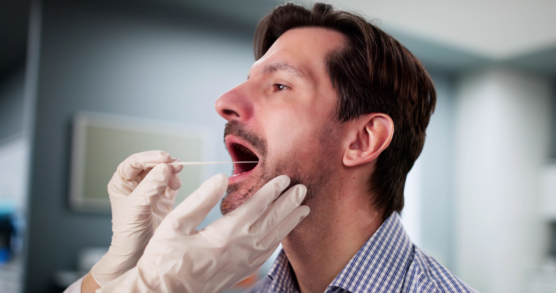 Medical Professional administering mouth swab DNA test