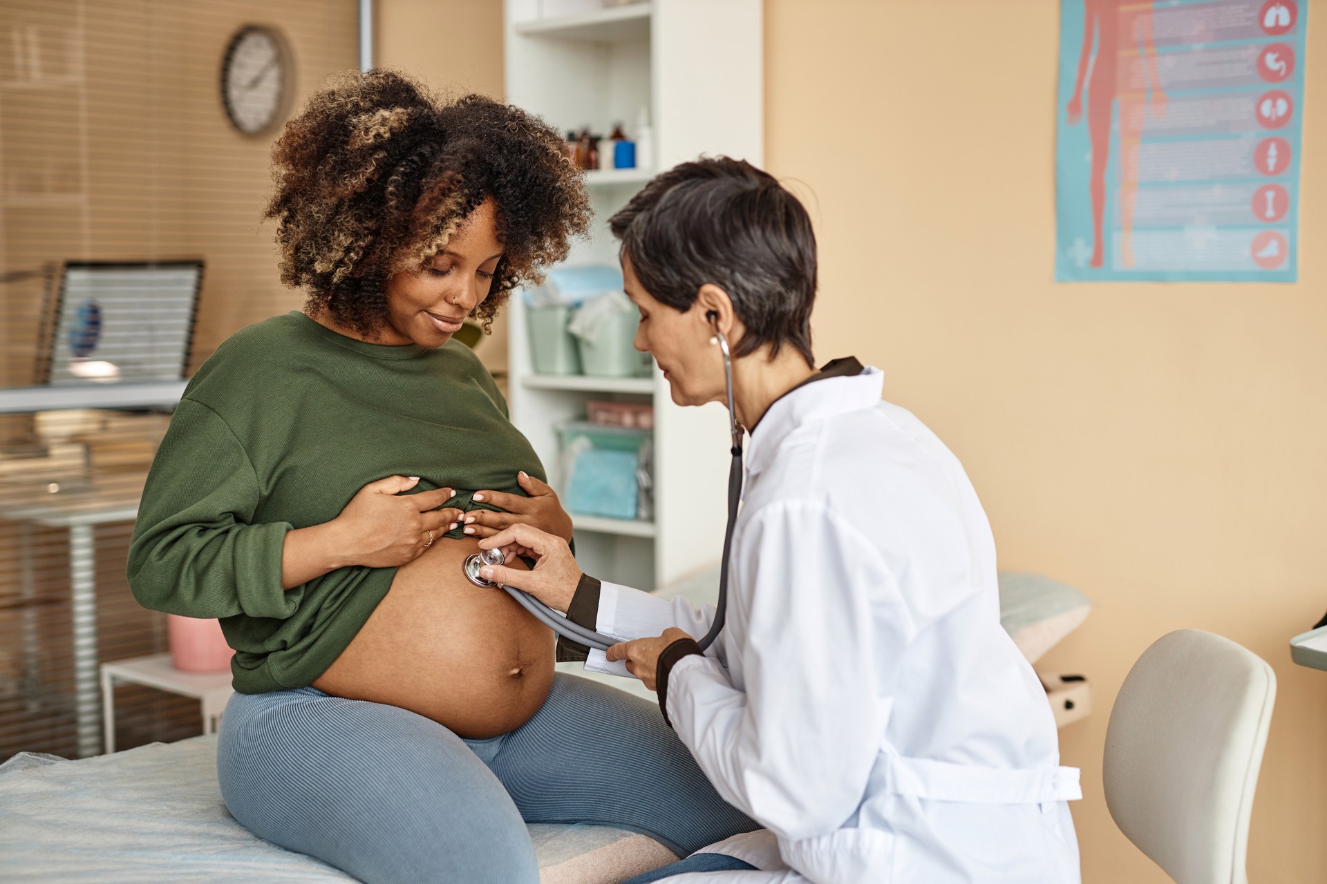 Doctor Examining Smiling Pregnant Woman