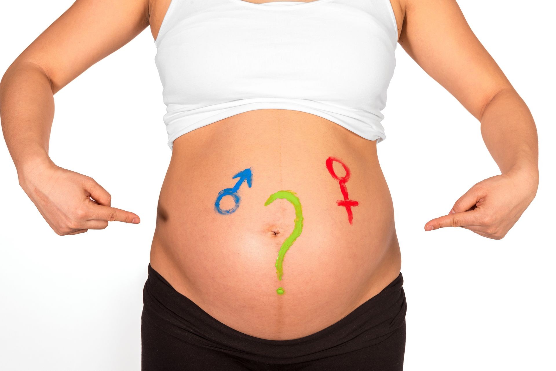Pregnant woman with question mark and gender symbols painted with finger paint on bare belly dealing with gender question in front of white background